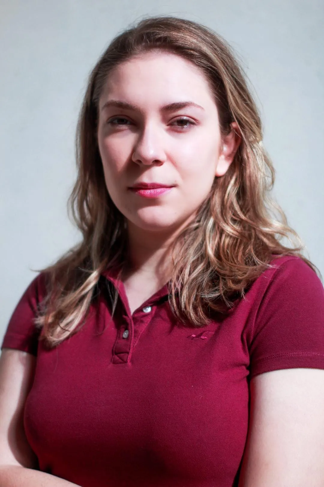 Headshot: Maria in a burgundy polo shirt